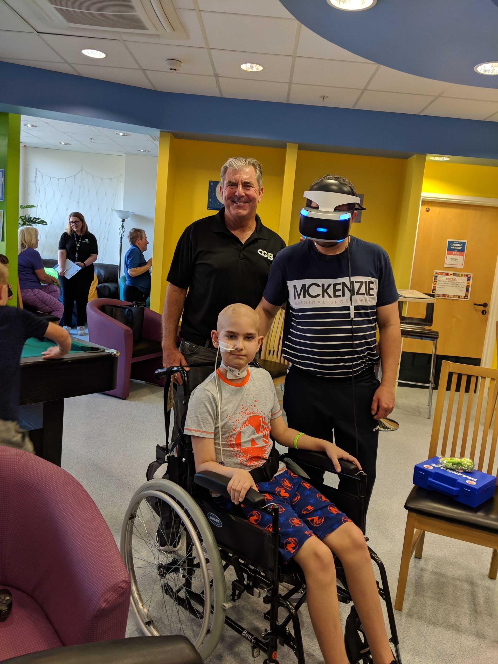 A young patient and his dad sharing a virtual-reality experience together