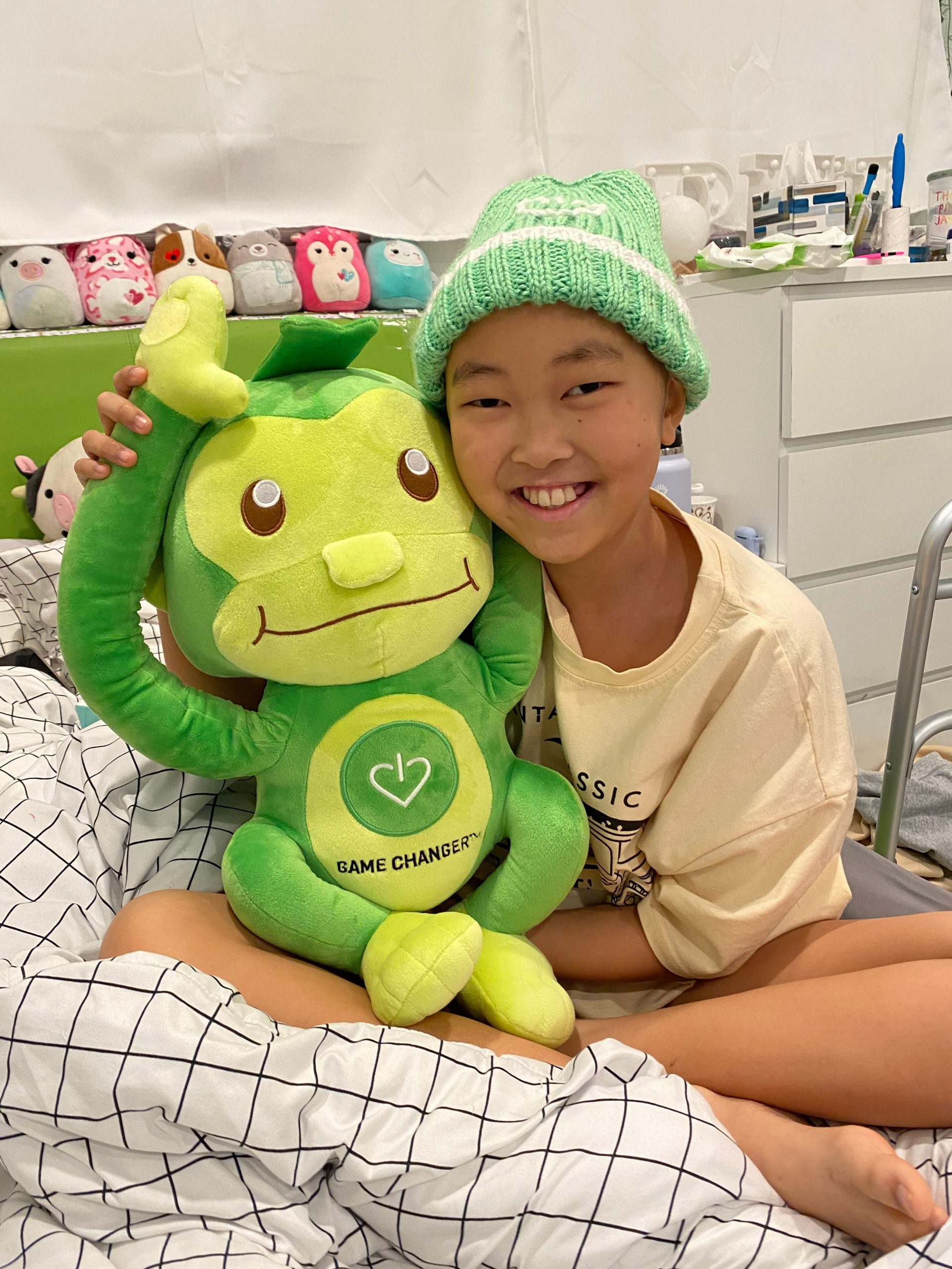A young patient holding a comfort gift delivered through GameChanger